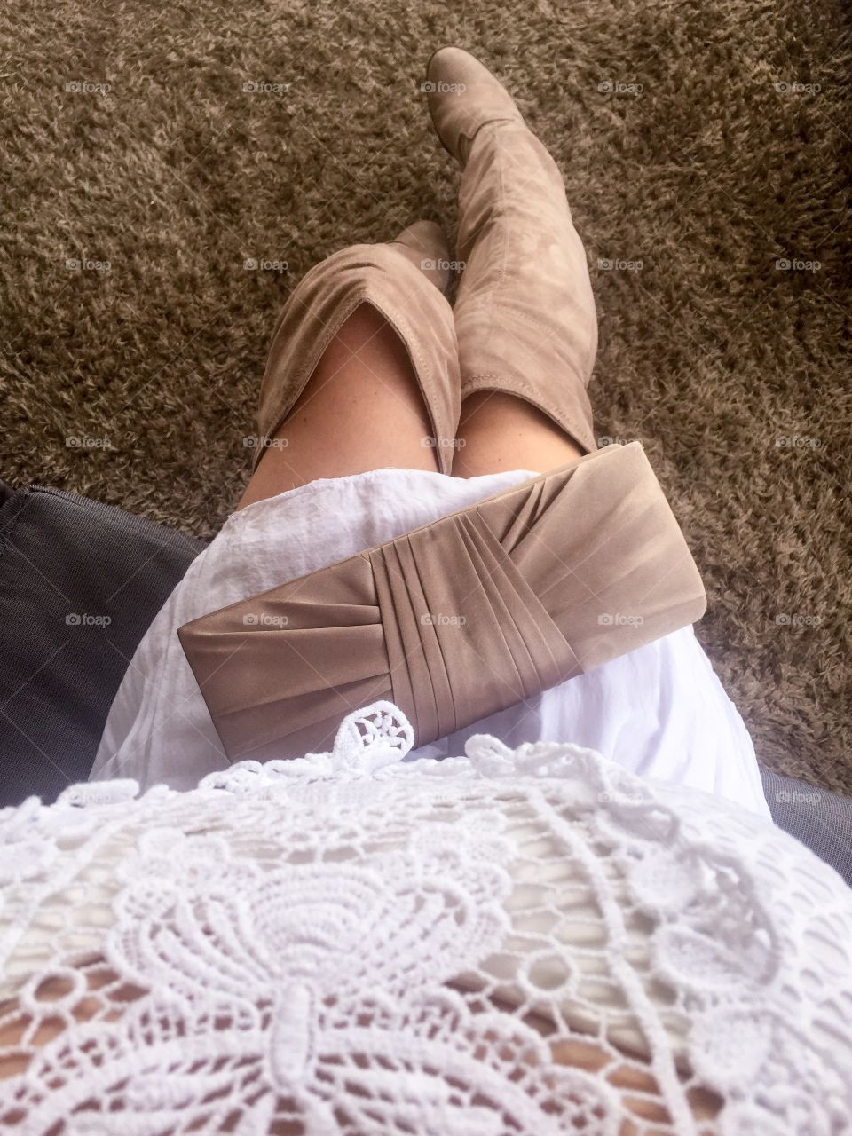 High angle view of woman sitting on sofa with purse