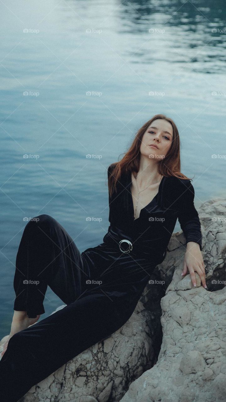 a beautiful woman on a rock