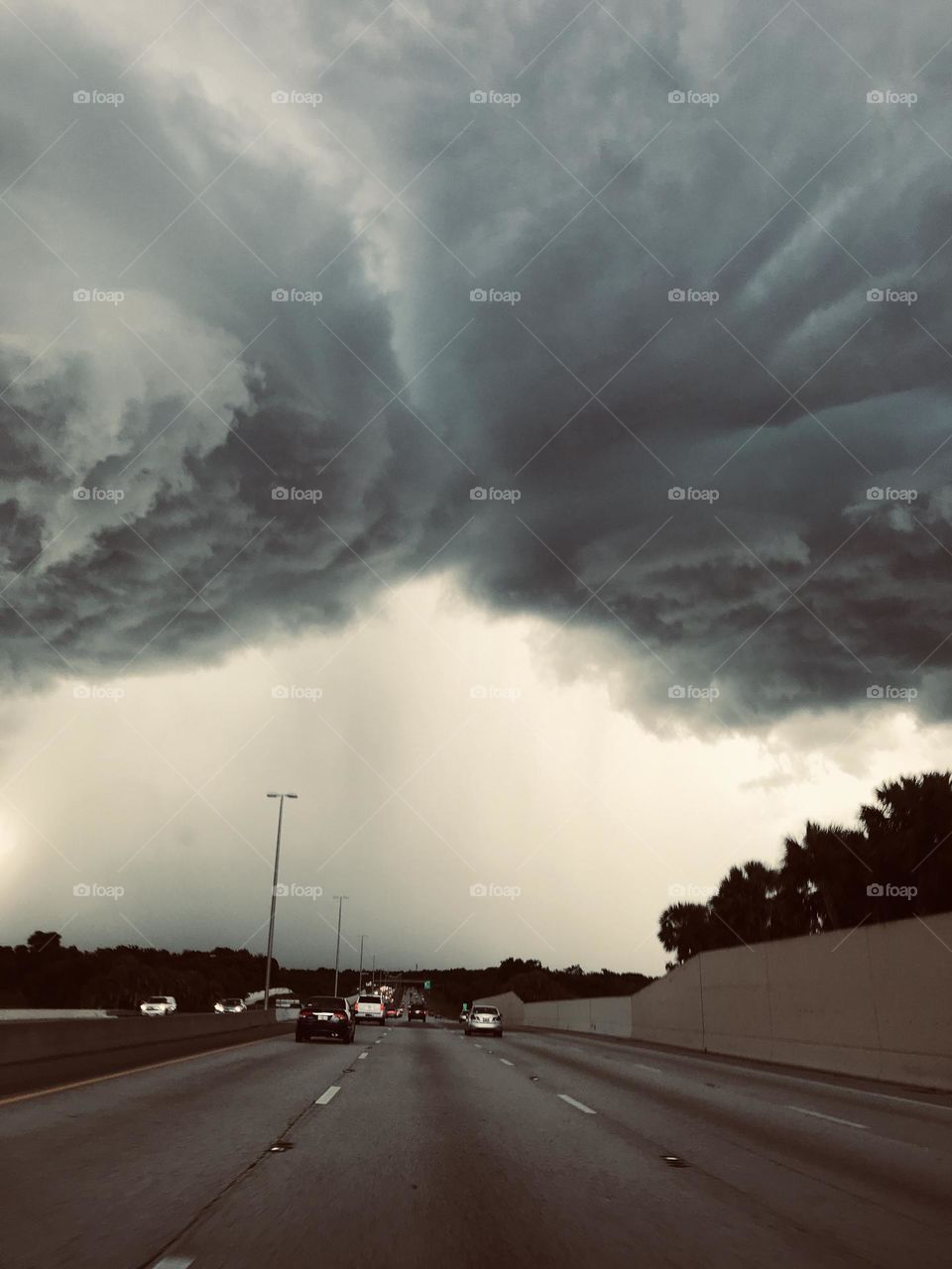 Clouds colliding together over highway 