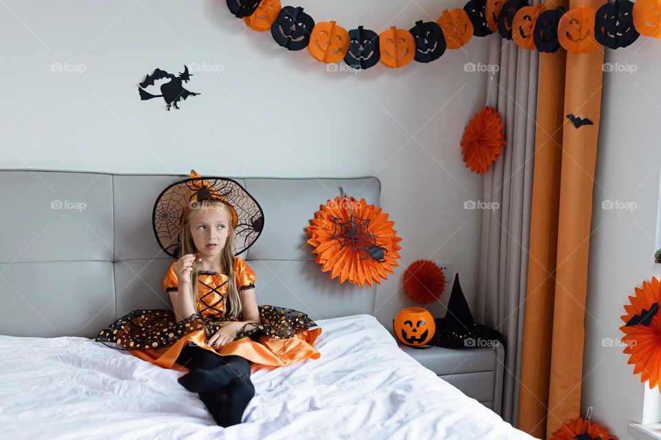 Happy kid celebrating Halloween at home 