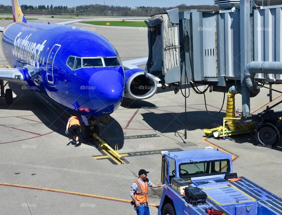 Airport workers getting plane ready for a flight 