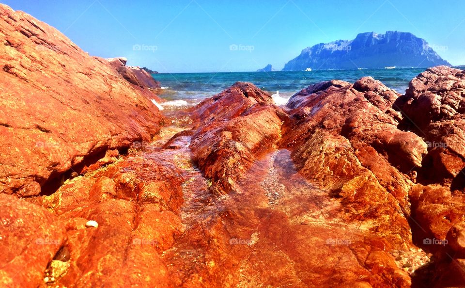 Red rocks at the bracht Baia Sardinia