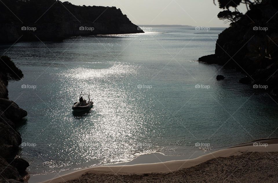 A boat in the sea on a sunset 
