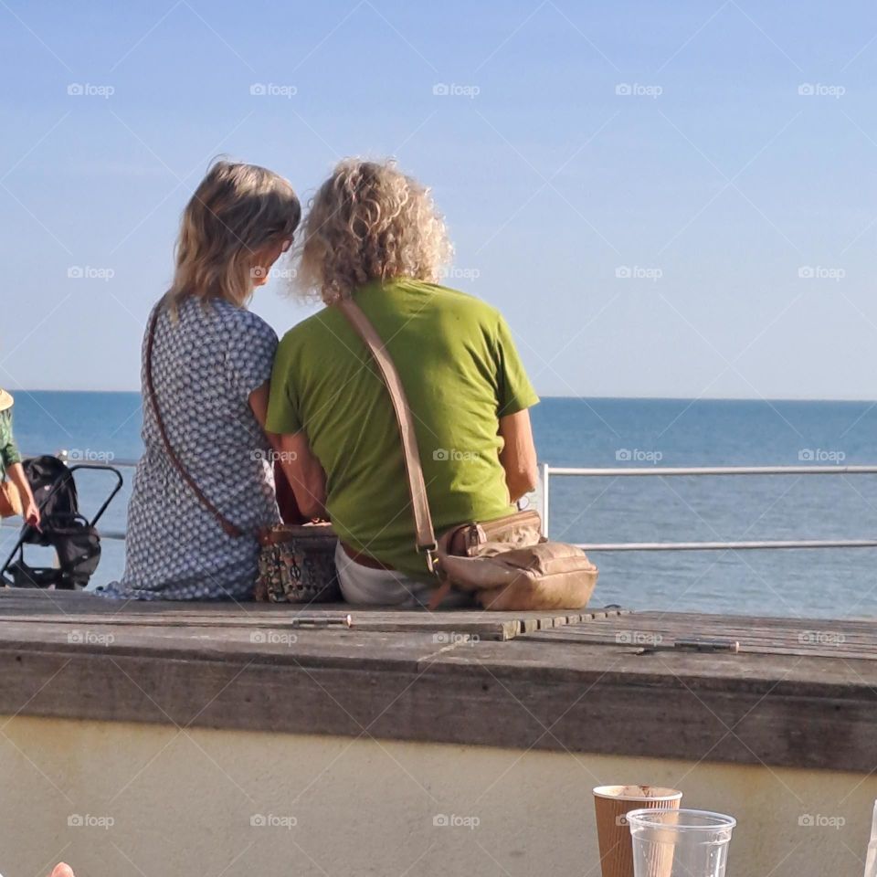 a couple enjoy sun at promenade with ocean