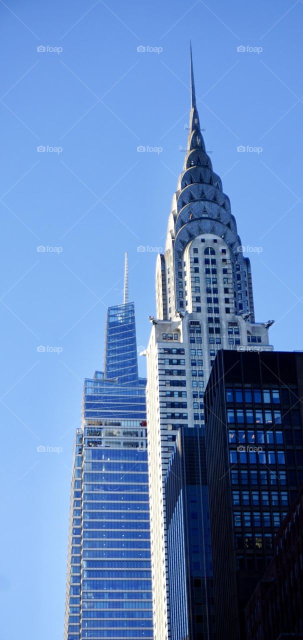 The Chrysler Building an Art Deco skyscraper from the 1930s shares the skyline with a more modern structure. 