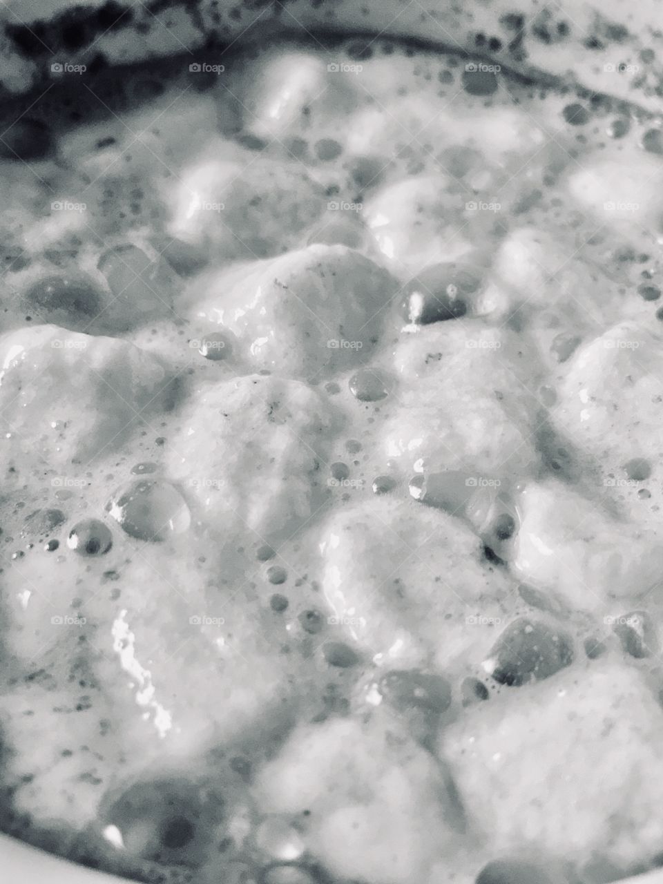 Melting marshmallows in hot cocoa in black and white 