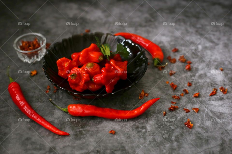 Hot red chilli peppers in the black plate