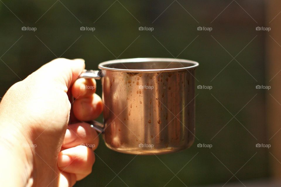 Mug with coffee on rustic wooden table