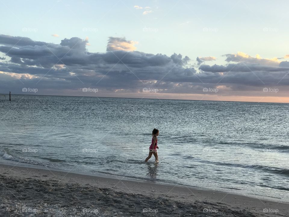 Little child enjoying the beach.