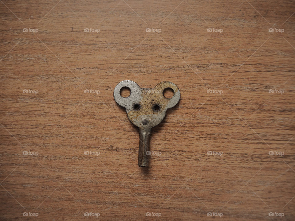 Mouse shaped key for wind mechanism on wood table