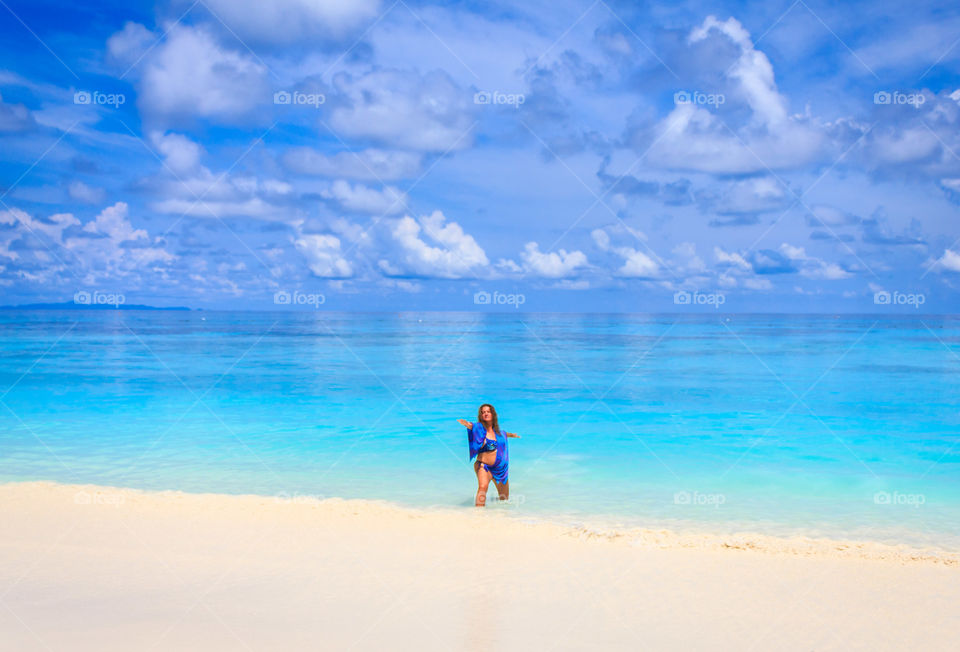 Woman standing on sandy beach
