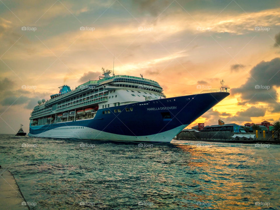 cruise ship passing through the harbor in the evening