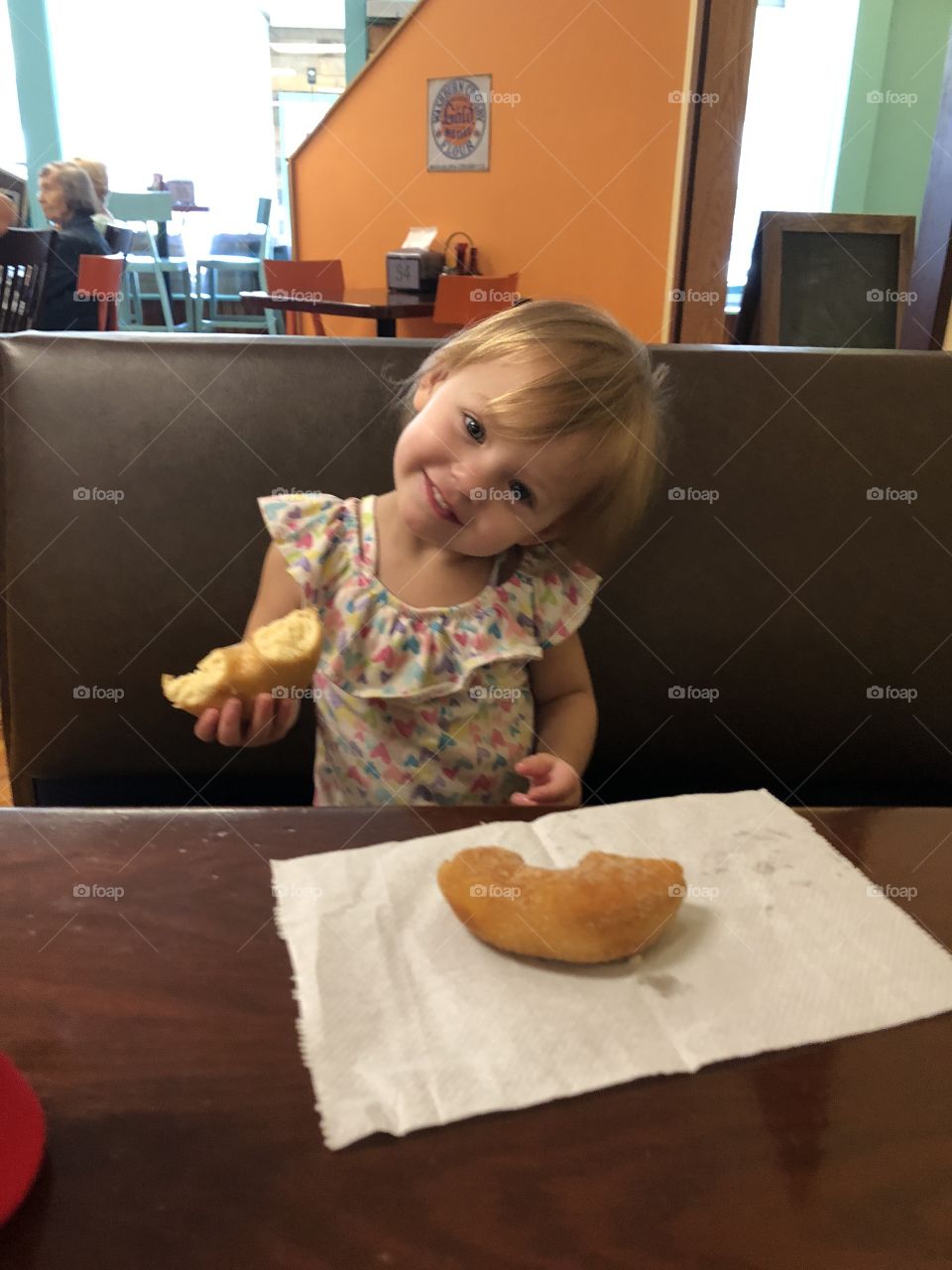 Little girl eating a doughnut 
