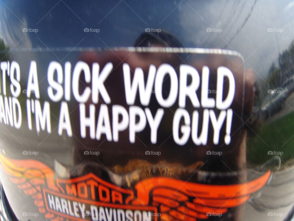 Photo of back of bikers helmet driving his Harley Davidson. I had to take this pic of his helmet as we rolled down the highway👍