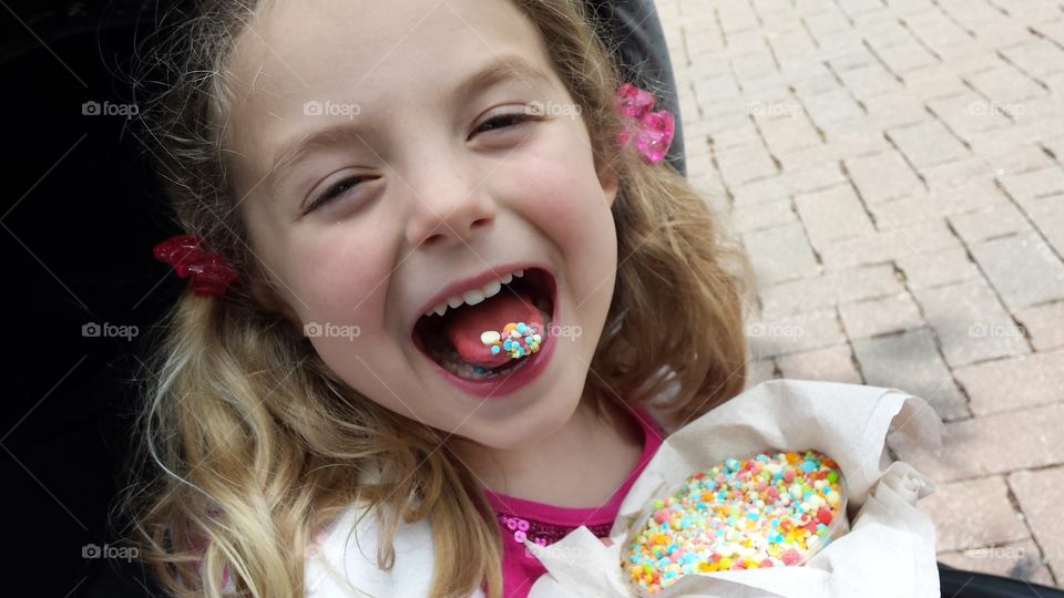 Close-up of a girl eating colorful candies