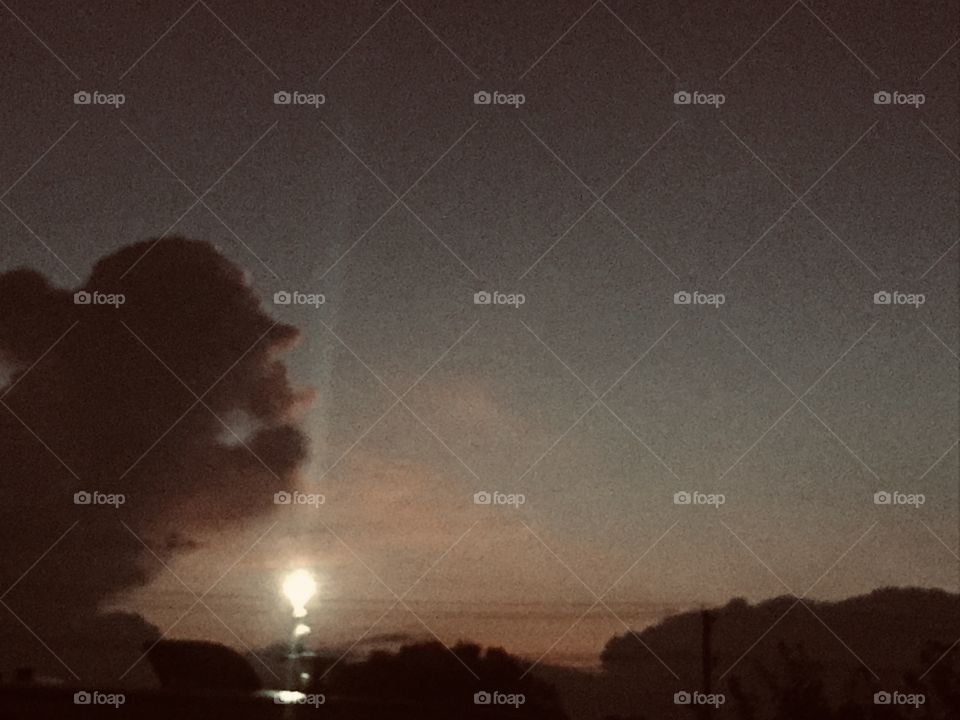 Awaking before Sunrise and positioning my iPhone on the window sill and snapping this Pic then later noticing that the cloud Figure had appeared and also the Perfect blend with cloud formation to see a Cap and Pony Tail in Perfect Position.