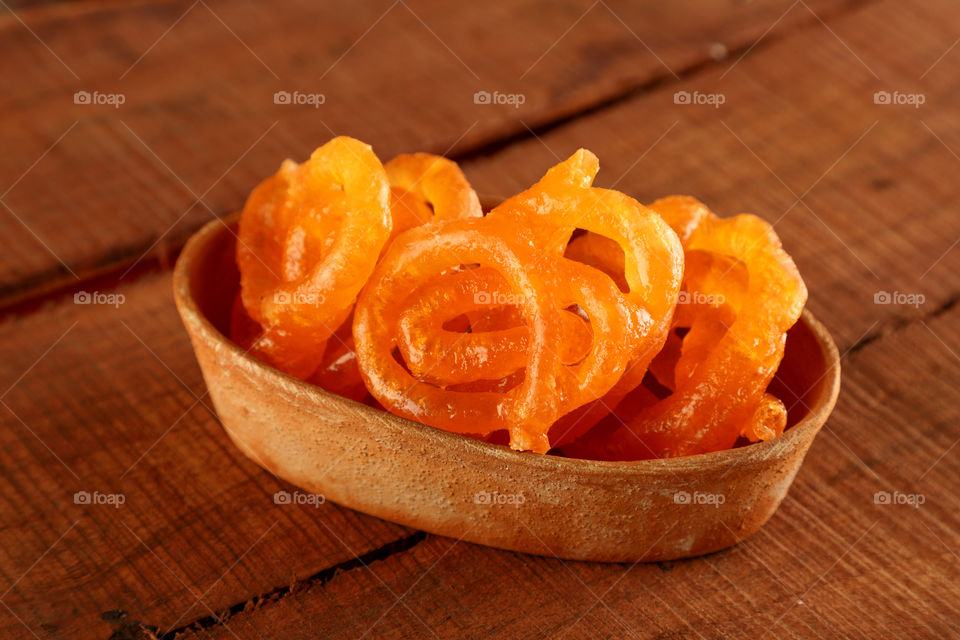 Indian sweet Jalebi in a pottery bowl