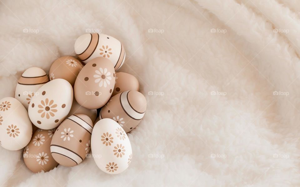 Painted eggs on a soft, fluffy white blanket