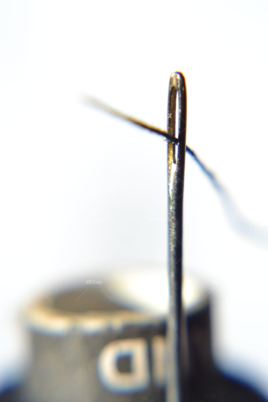 Thread going through a needle
