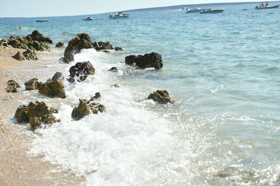 sea ​​water beats against stones