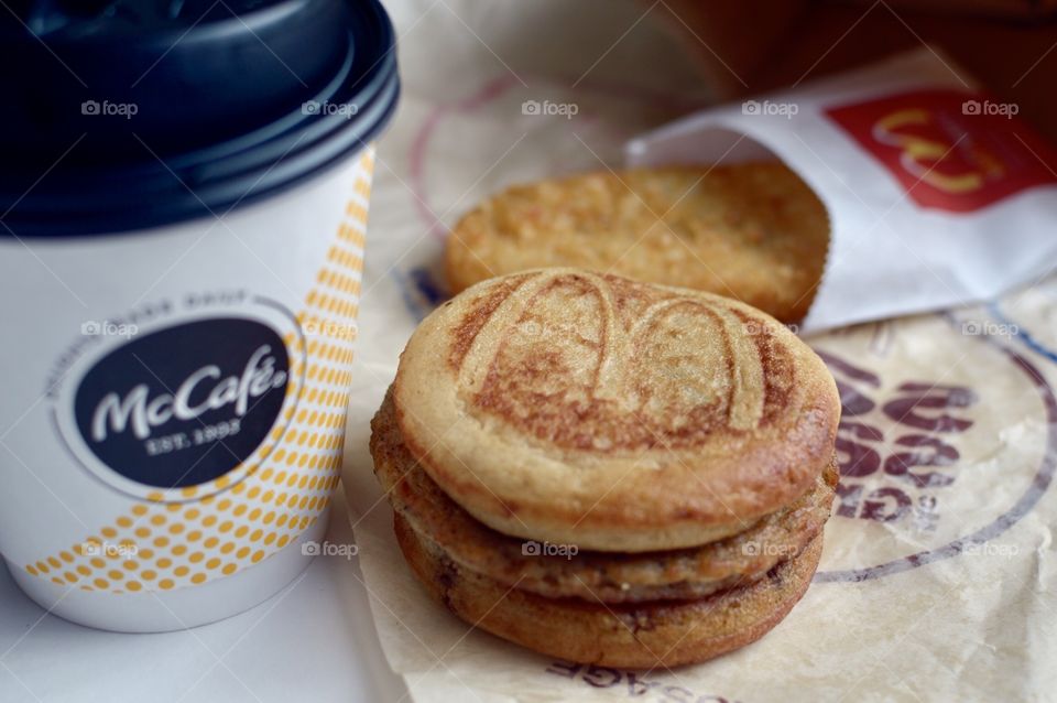 McDonald’s Mc Café sausage McGriddle hash brown close up side flat lay