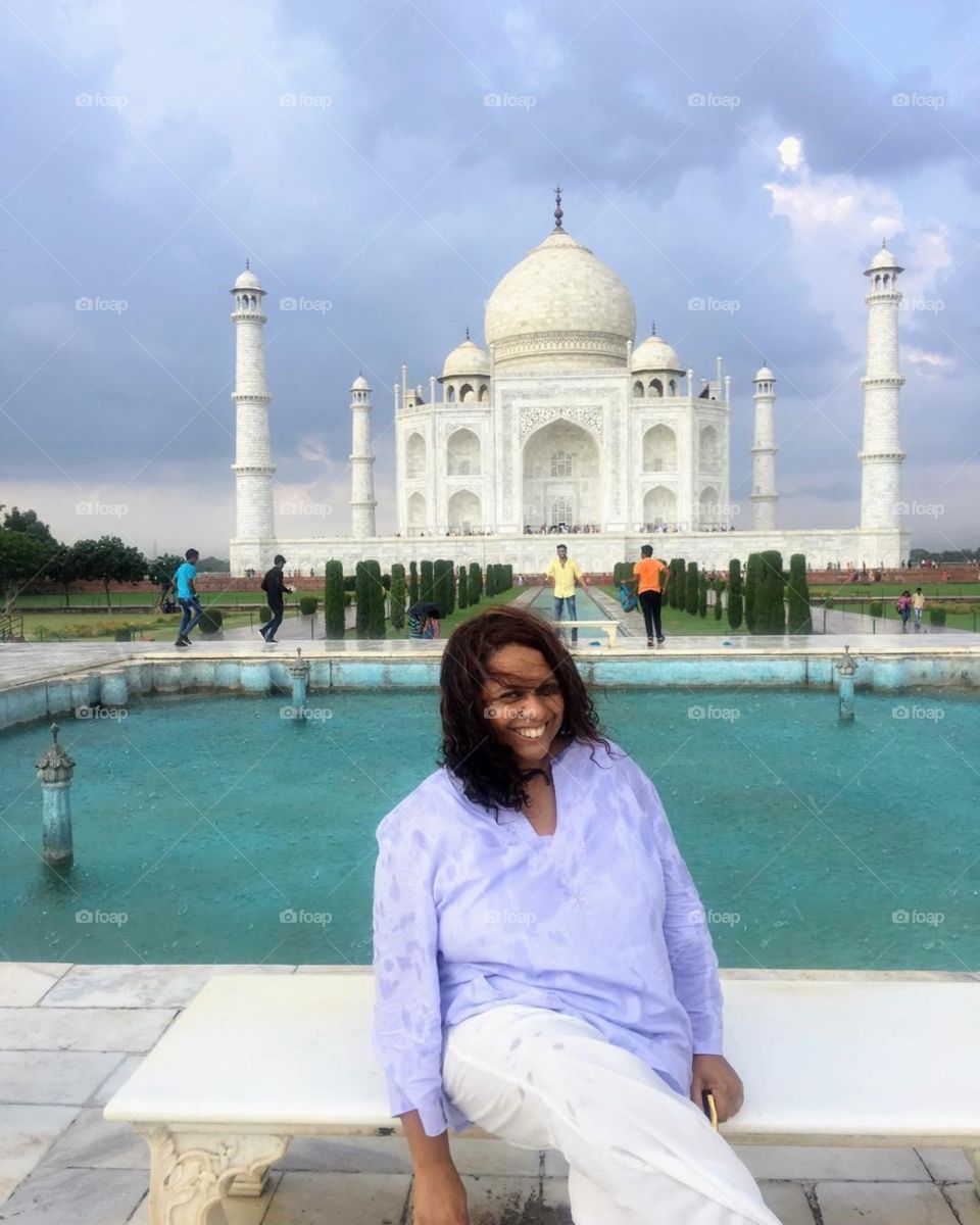 Seated in front of the Taj Mahal 
