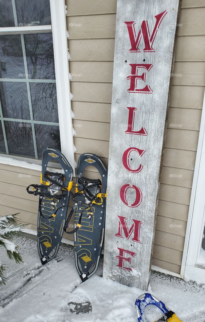 snow shoes on welcome front porch