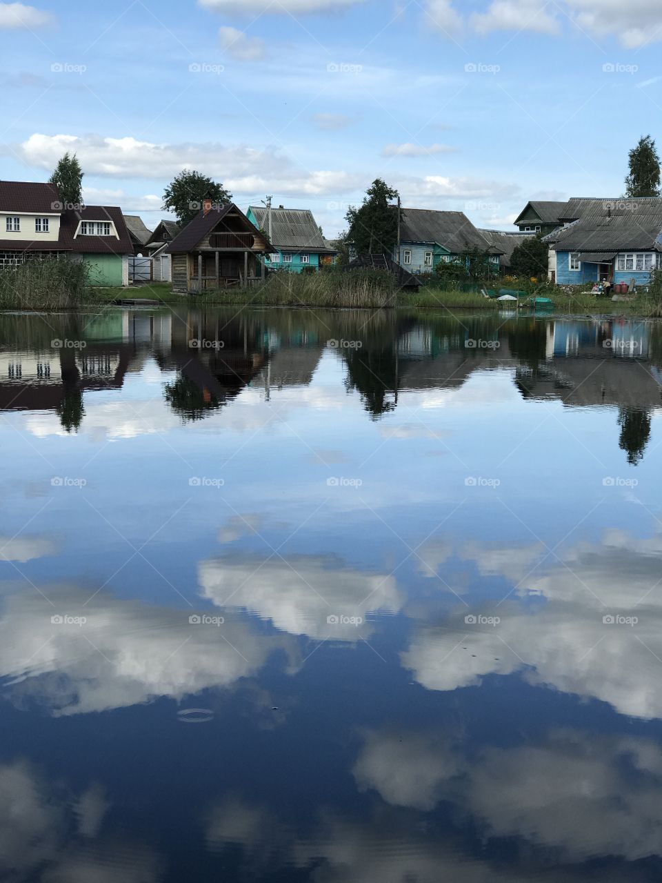 Village. Countryside. Polonovka lake. Lake. The reflection in the water. Clouds.