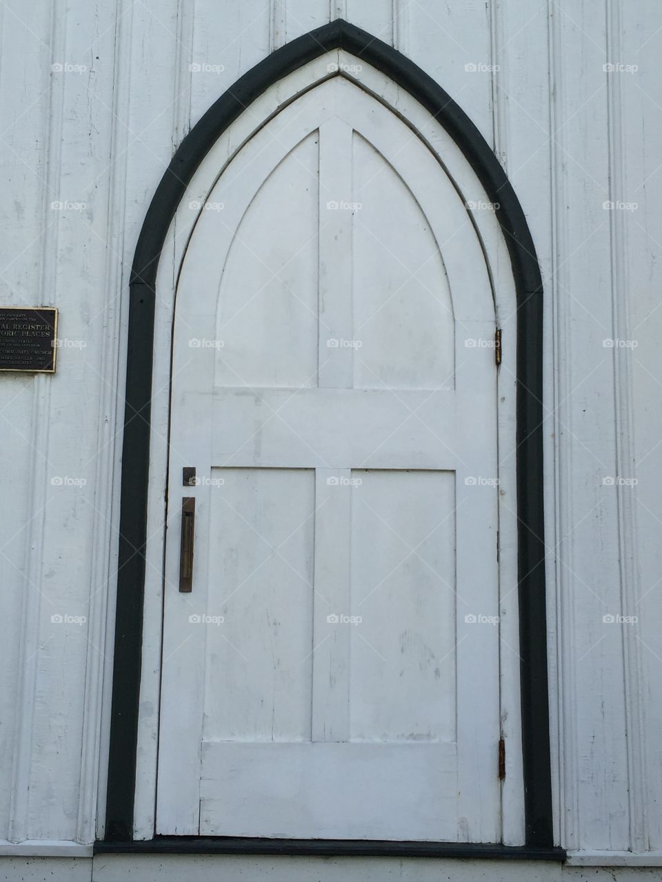 Front door to an old white church located in Eagles Bay.  Solid, wooden door.
