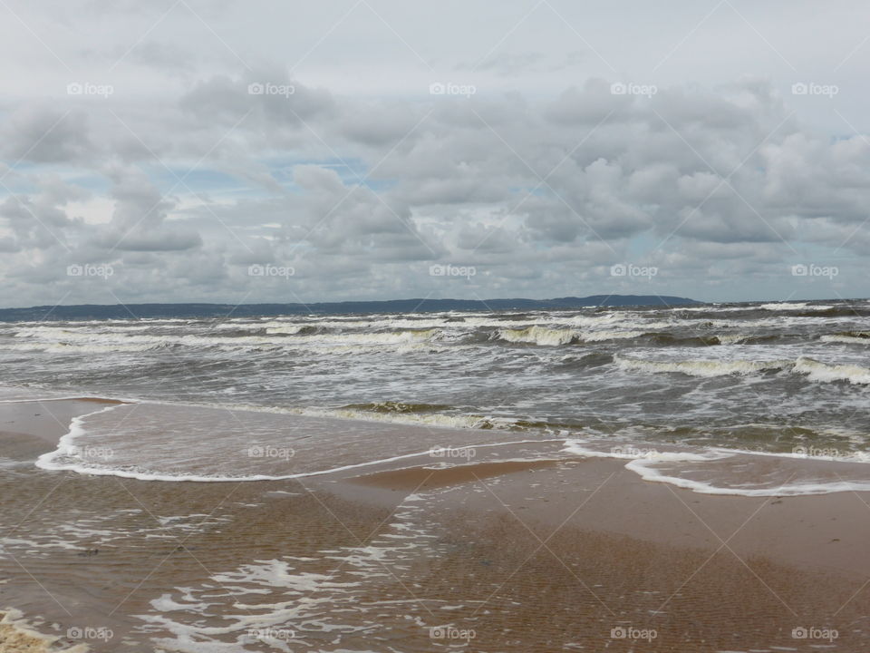 waves rolling in a stormy grey day