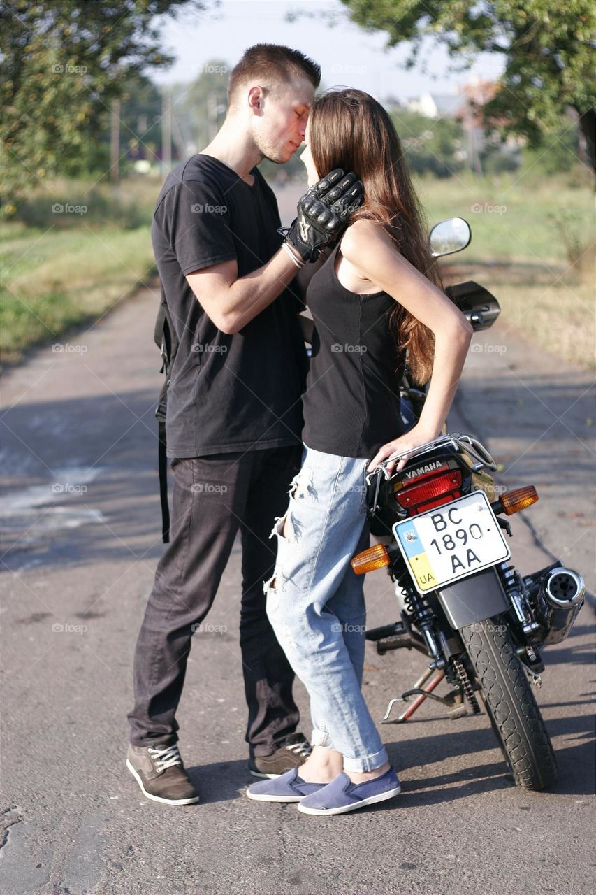 a warm date between a guy and a girl at a motorcycle