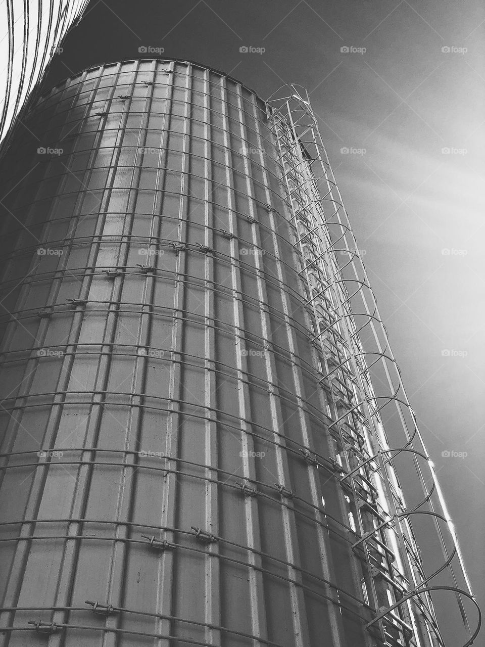 Black and white architecture image, tower of metal on a silo, shades of gray on architecture, patterns in black and white, monochrome architectural designs 