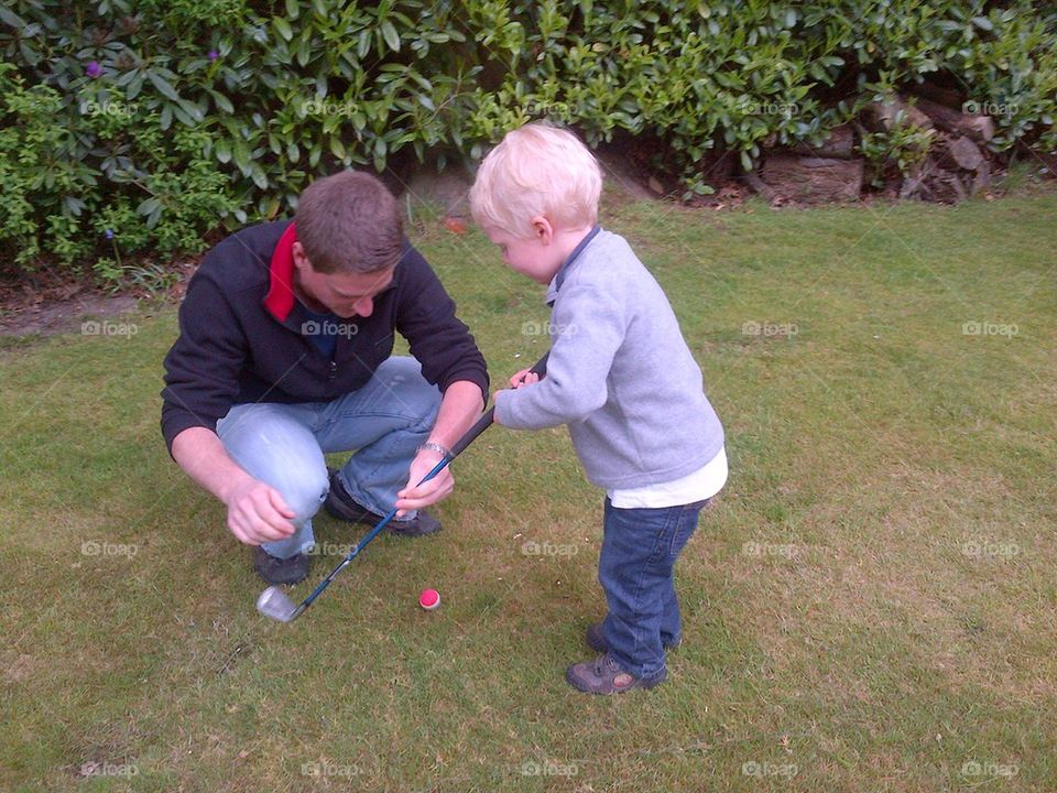 Young boy learning golf