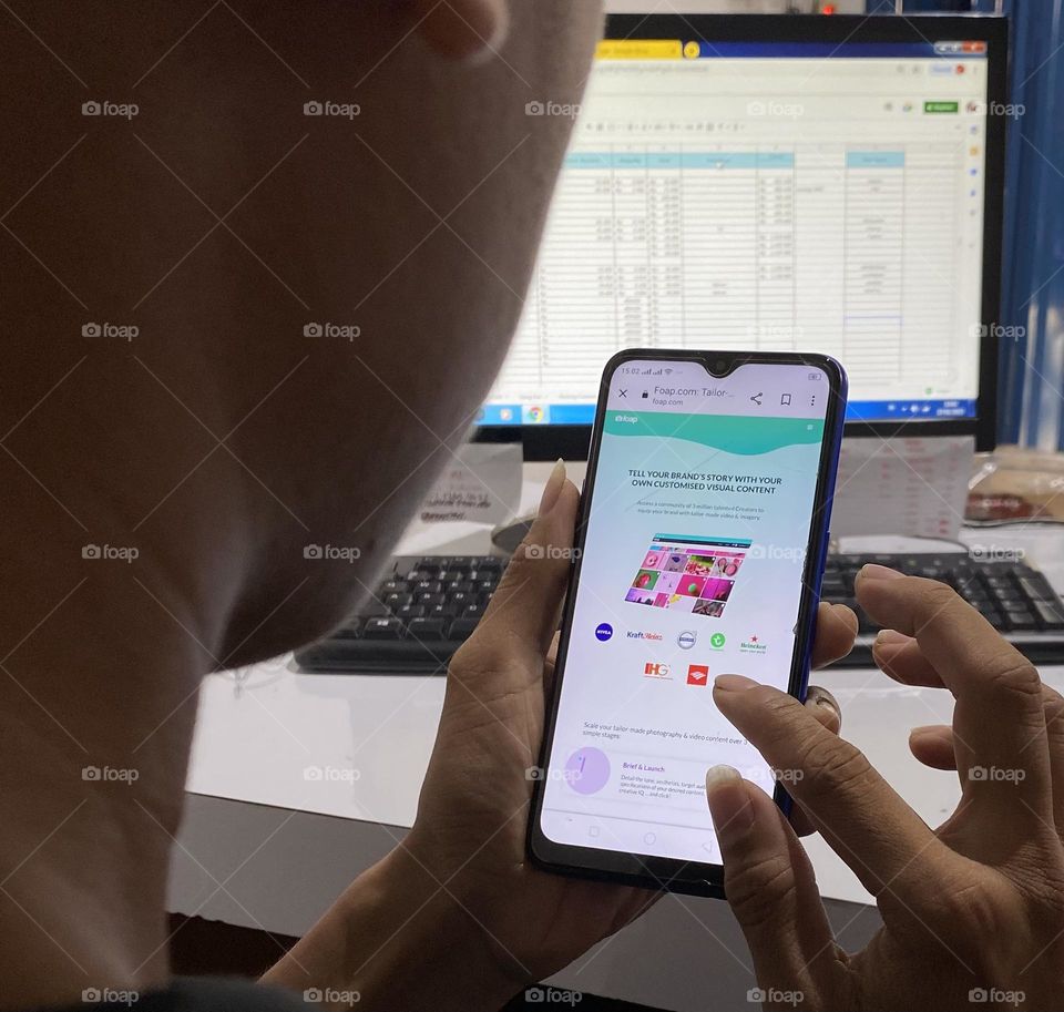 A man is opening the Foap app on his smartphone