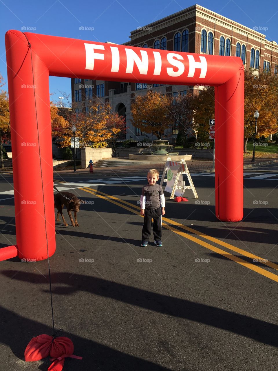 Boy standing at finish gate on street