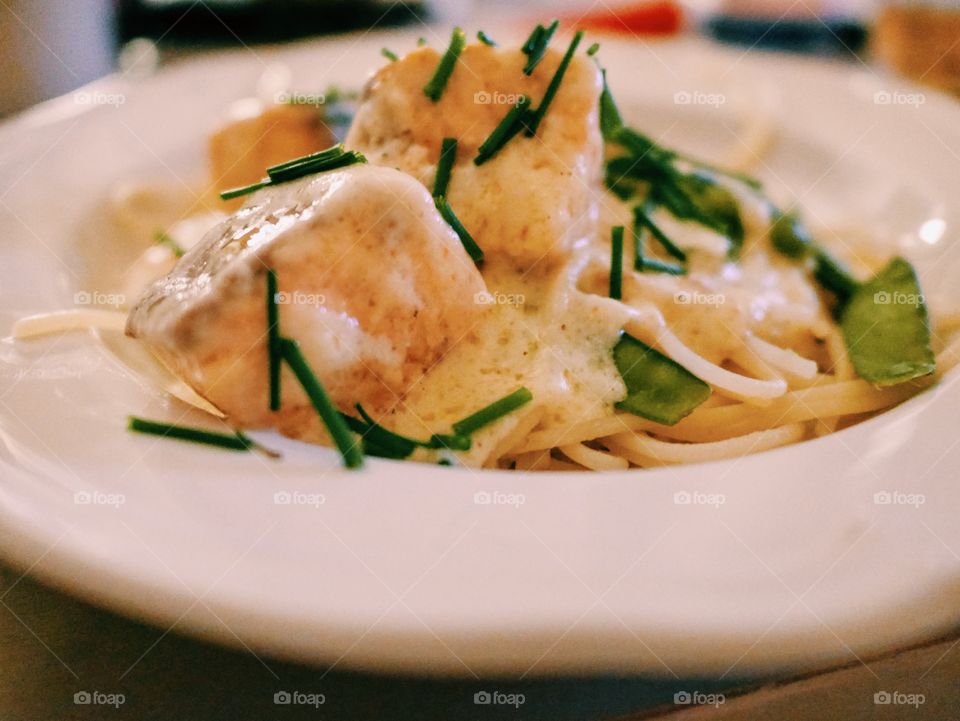 Pasta with salmon served in plate