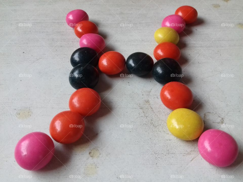 color tiny sugar candy.very sweet solid candy eating by childs.Name art making by me.