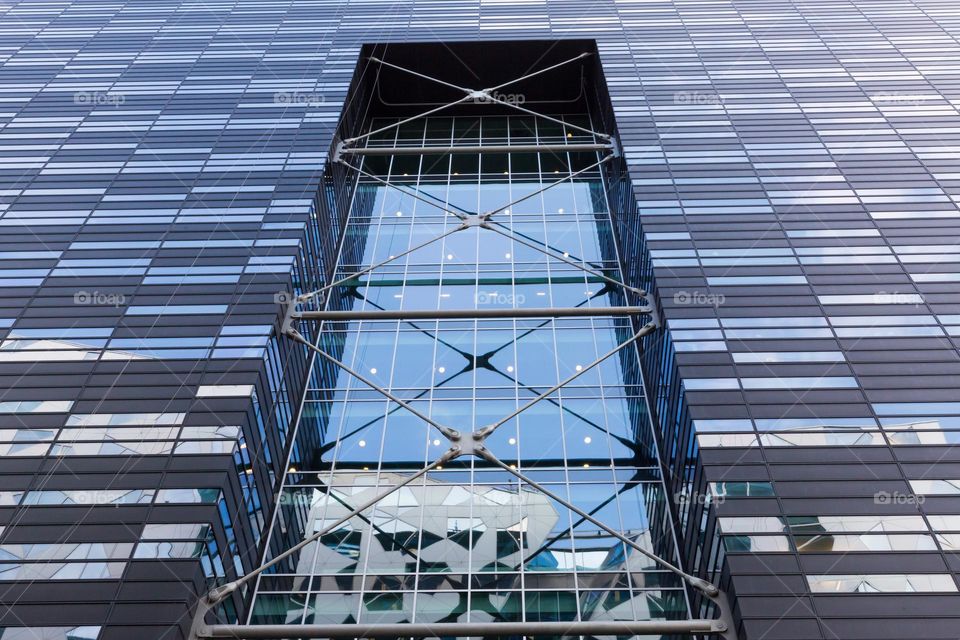 Modern architecture, looking up on office building covered with rectangle shaped glass windows, Oslo Norway 