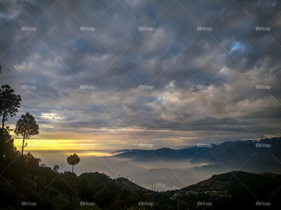 beautiful sunset, cloudy sky and mountains.