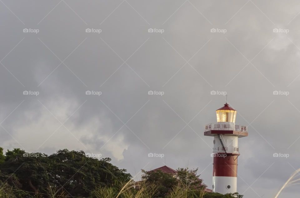 Evening Lit Lighthouse At The Top Of The Hill