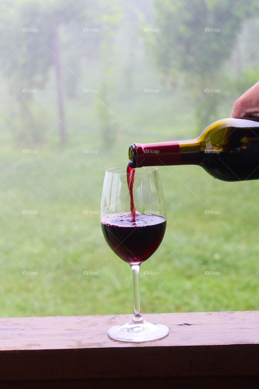 Pouring red wine into the glass