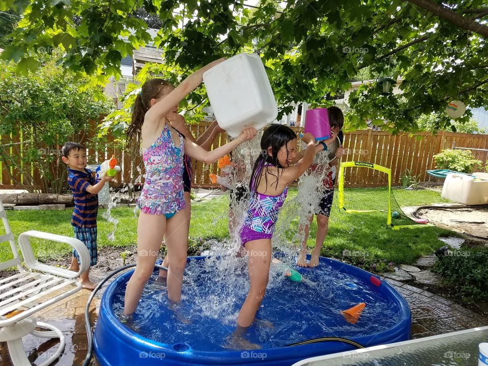 Children splashing in a water fight