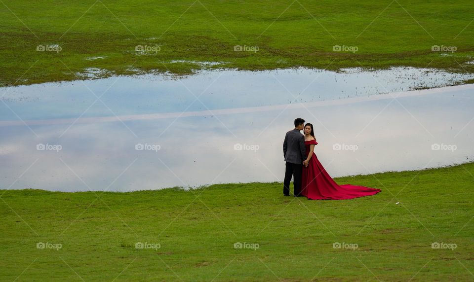 The red. Freshly married couple out for a romantic photoshoot.