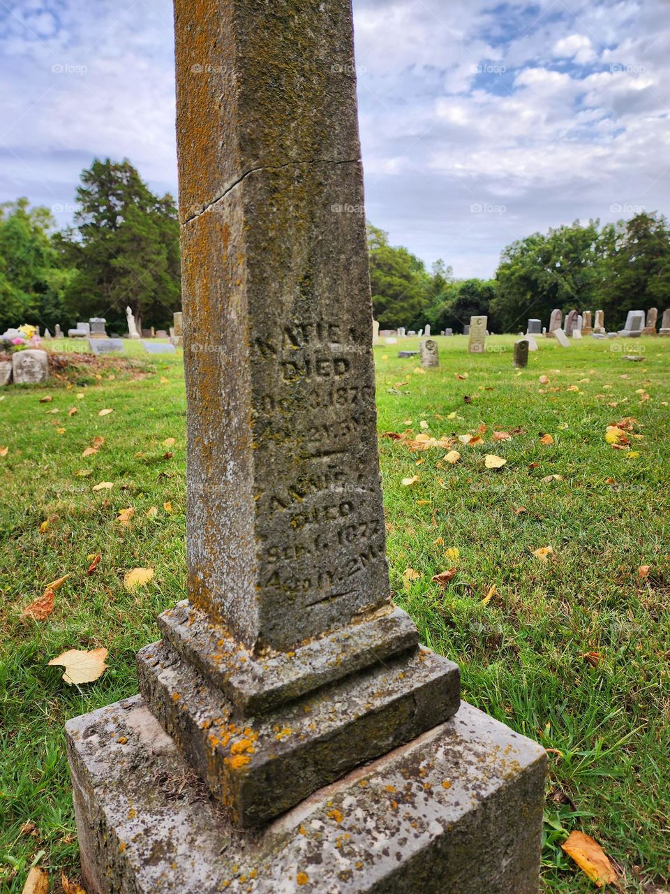 Weather has discolored an old grave marker that is more than a century old