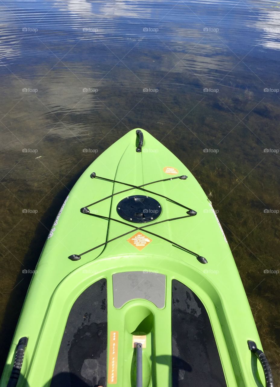 Bright green paddleboard floating in the lake