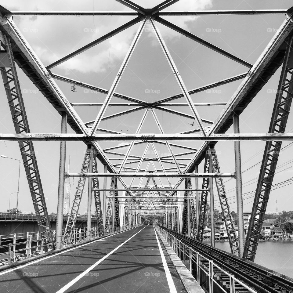 Black and white shot of steel bridge in Thailand