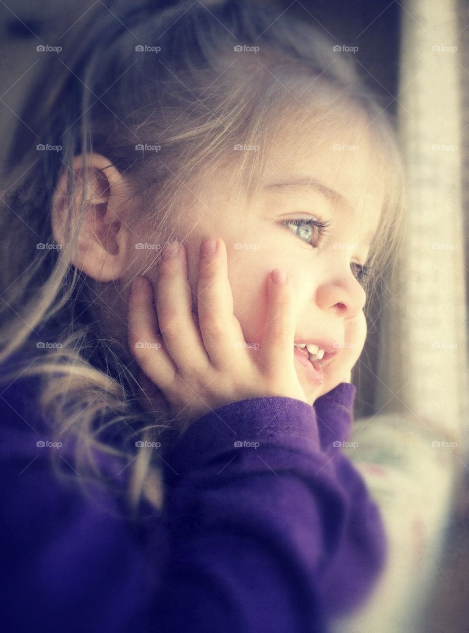 Girl looks out window