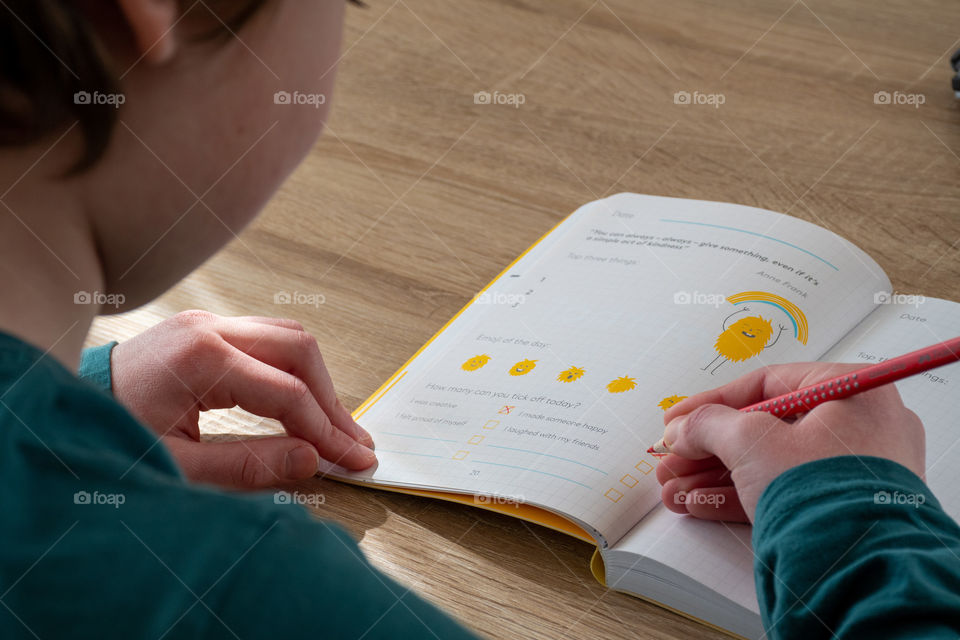 A Boy Writing in his Junior Continuation Journal