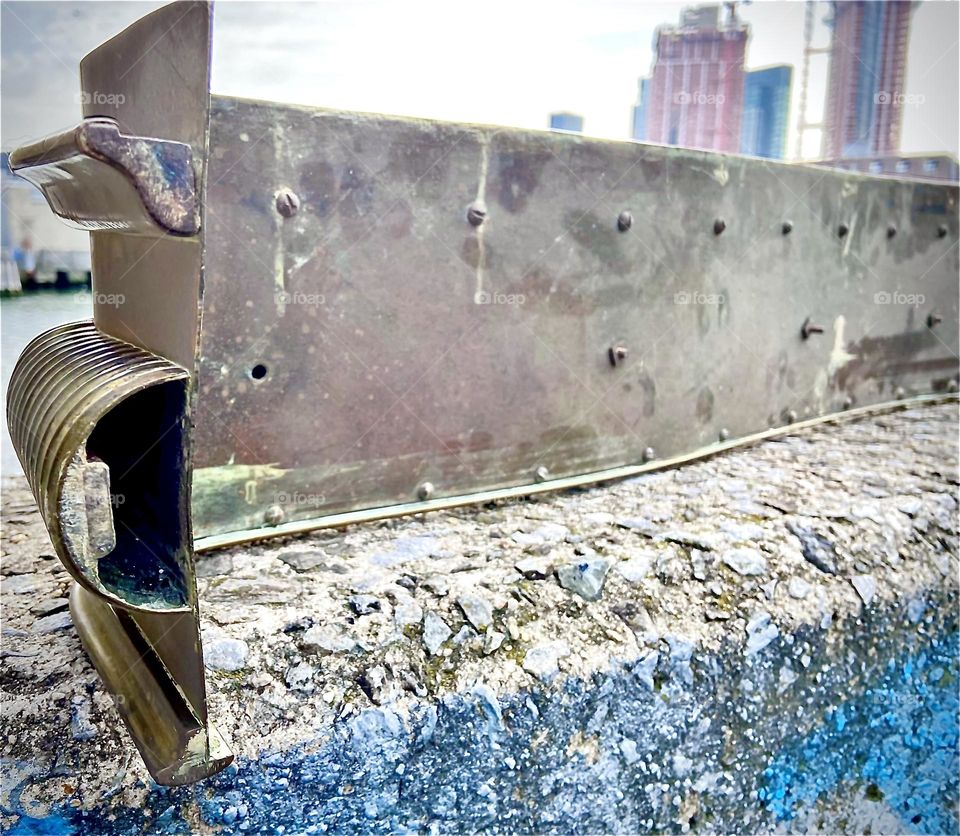 The rear of the old style bronze fireplace fender with ornamentations and rounded edges, not to forget the beautiful warm golden glow exuded by the lavish material. The fender weighs in at around 40 or 50 pounds. 2022. Hypnotic Productions