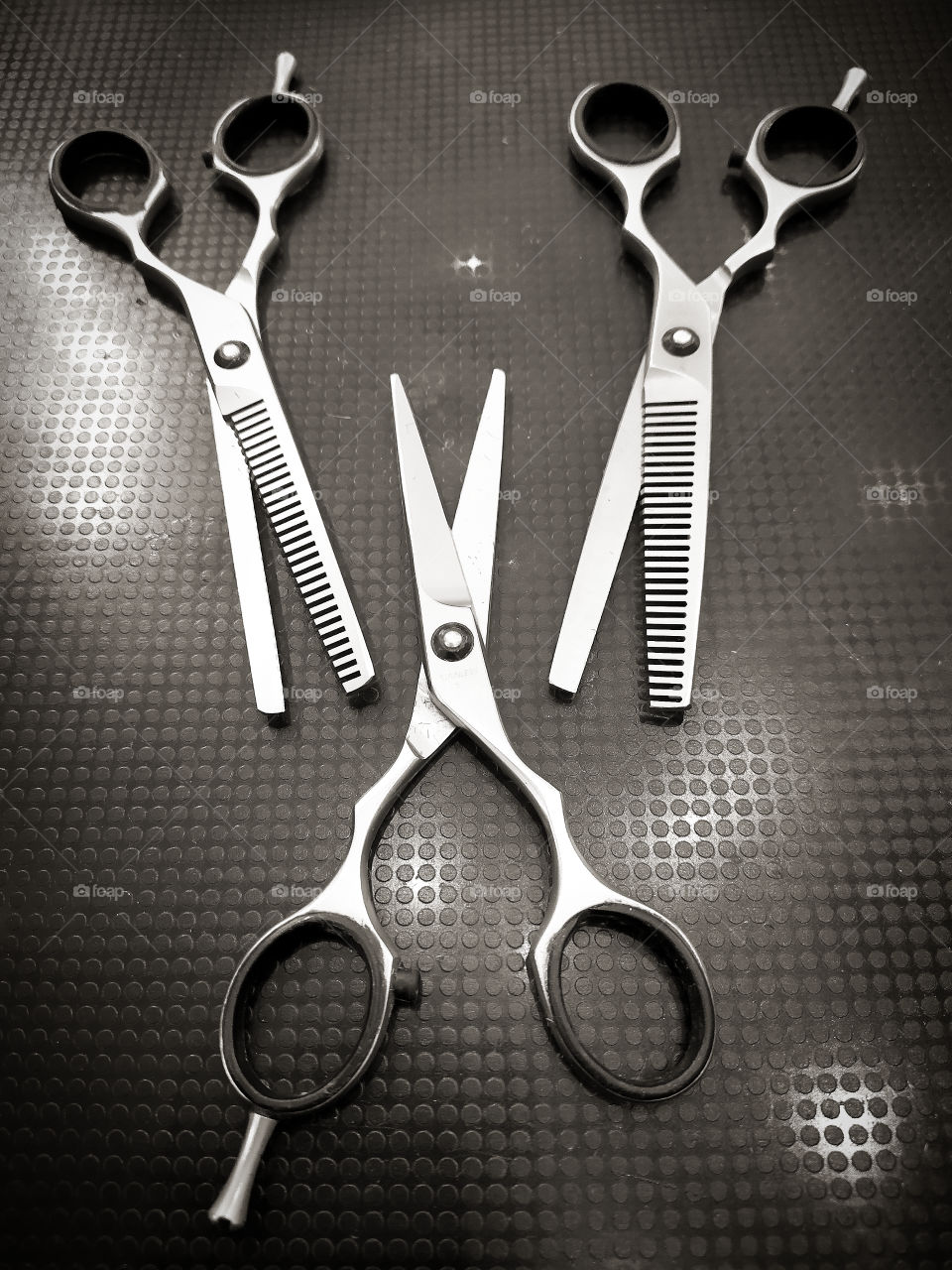 Three professional scissors for cutting hair